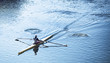 Person sculling in a racing canoe