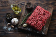 Raw fresh ground beef meat with seasonings, high angle view