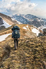 Wall Mural - Young man climb on mountain hill