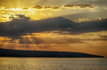 Wall Mural - rays of sun shining through the clouds.