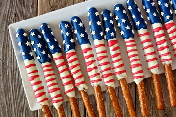 Group of Fourth of July American flag themed pretzel rods on a white plate