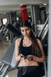 © pro100pasha - Beautiful girl with a phone in the gym