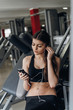 © pro100pasha - Beautiful girl with a phone in the gym
