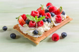 Fototapeta  - Closeup of waffle with berry fruits and whipped cream
