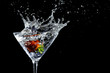 Strawberry plunging into a martini glass, making a splash