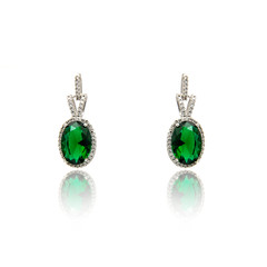 Pair of emerald earrings isolated on white
