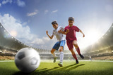 Fototapeta Sport - Childrens are playing soccer on grand arena