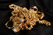© rocklights - scrap gold jewellery including chains, bracelets and rings on a black background