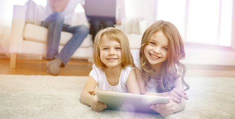 Wall Mural - happy little girls with tablet pc computer at home