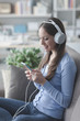 © stokkete - Girl listening to music with her smartphone