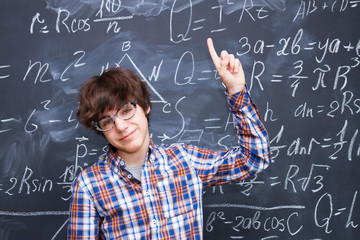 Boy and blackboard filled with math formulas