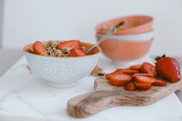 Fresh strawberries , yogurt and homemade granola for healthy bre