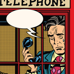 Wall Mural - Retro man crying in the red phone booth