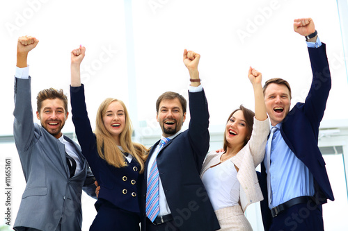 Fotografía Business team celebrating a triumph with arms up