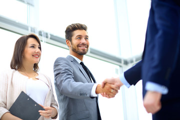 Wall Mural - Business colleagues sitting at a table during a meeting with two