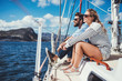 © Jacob Lund - Young couple sitting on yacht in sea