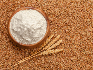 Wall Mural - Flour in bowl and grains of wheat.