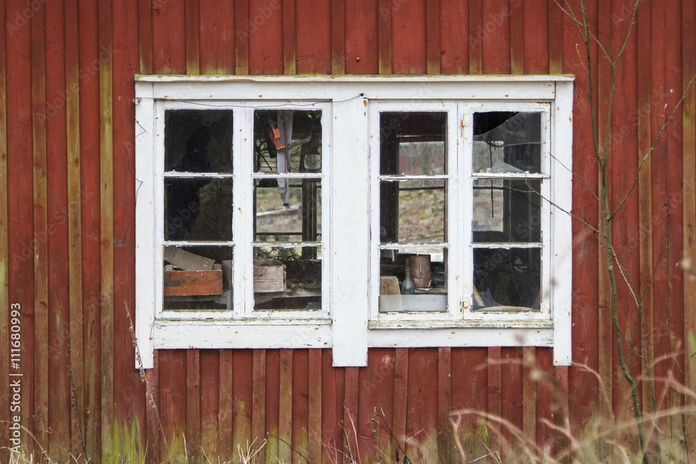 Vita spröjsade fönster på en gammal träbyggnad Stock Photo | Adobe Stock