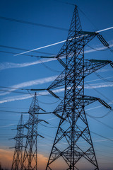 High voltage pylons on blue sky