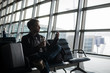 © romankosolapov - man waiting at airport lounge texting with his smart phone