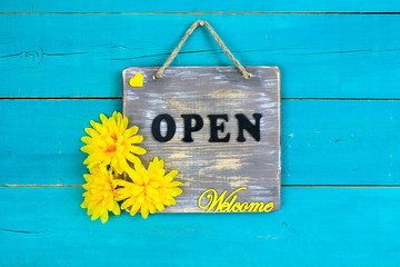 Wall Mural - Welcome OPEN sign with yellow flowers hanging on door