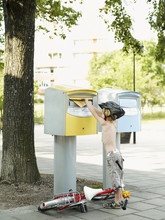 A Boy Dropping A Letter Into A Box, Sweden.