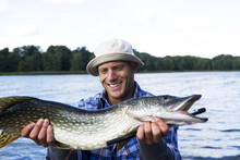 A Man Holding A Pike, Sweden.