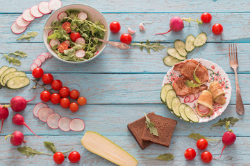 Pork meat with fresh vegetable salad on old blue wooden backgrou