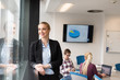 © .shock - portrait of young business woman at office with team on meeting