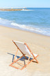 © aquar - Back View Of Woman's Hat and Deckchair On Sandy Beach