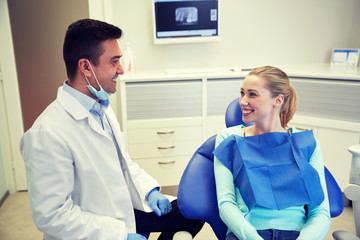 Poster - happy male dentist with woman patient at clinic