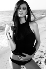 Wall Mural - gorgeous sexy girl with dark hair posing on beach