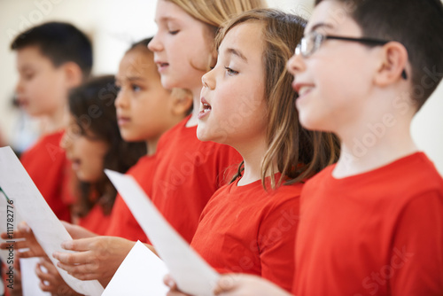 Fototapeta Group Of School Children Singing In Choir Together