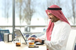 Arab saudi man working online with a laptop