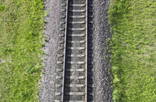 Railway Top View. Railroad And Green Grass On The Sides. The Part Of Rail Track For Trains.