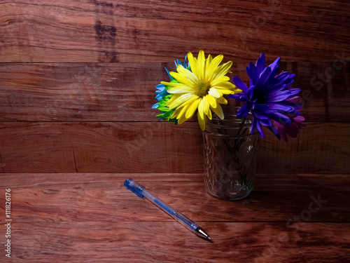 Fotografie, Obraz Vibrant Colorful Pens And Daisies On Warm Wood Desk Top