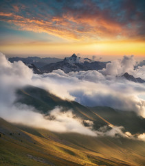 high mountain ridge in the clouds during sunrise. beautiful panoramic landscape