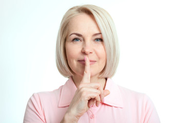 Wall Mural - portrait woman with finger on lips, or secret gesture hand sign isolated on white background