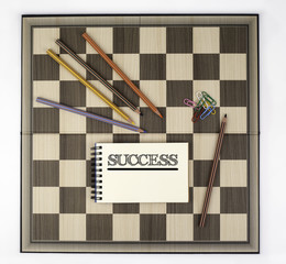 Wall Mural - Success - Notebook with text on a chess board