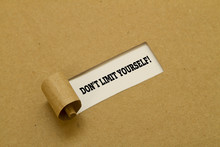 DO NOT LIMIT YOURSELF Message Written Under Torn Paper.