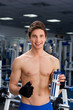 Man smiling in gym after exercising