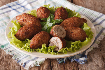 Arabic meat appetizer kibbeh close-up on a plate. horizontal
