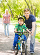 © Ermolaev Alexandr - father teaches his son to ride a bike