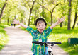 © Ermolaev Alexandr - Portrait of a joyful child on a bicycle in a summer park