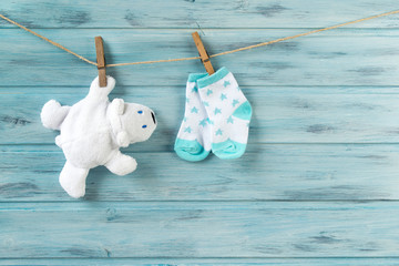 Wall Mural - White toy bear and baby socks with stars print on a clothesline