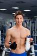 Man smiling in gym after exercising