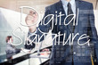 Businessman is writing on transparent board, he is preparing for presentation about: Digita Signature