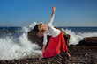 Girl doing yoga. Ocean in background