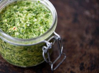 Homemade parsley and basil pesto in a jar