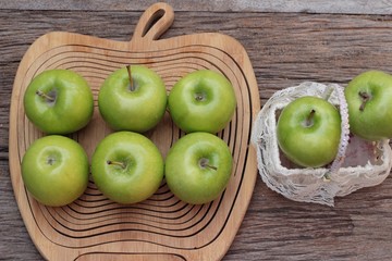 green apples is delicious on wood background.